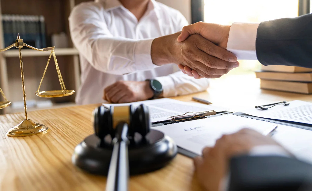 Orlando personal injury lawyer shaking hands with a personal injury client over a desk