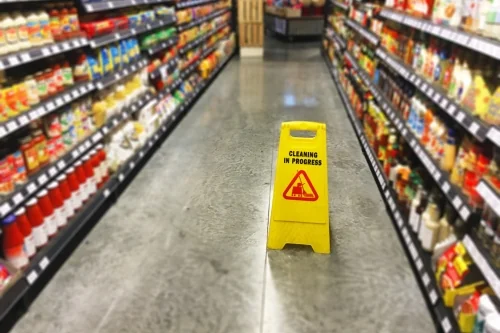 Caution sign in a store warning of potential slip and fall accident