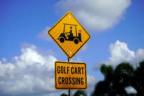 Golf cart crossing sign to avoid accidents in Florida between golf carts and automobiles
