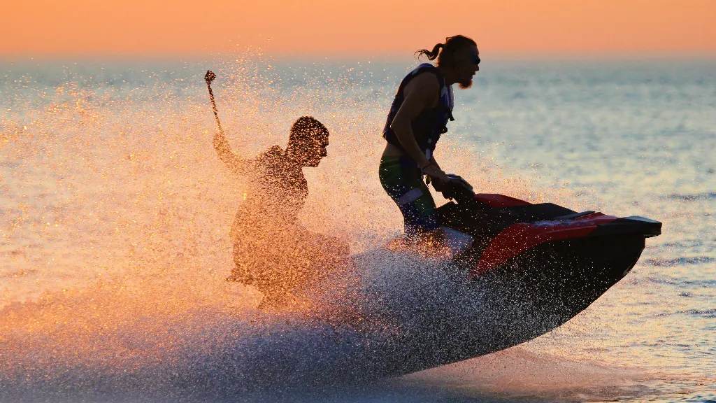 two people riding a jet ski on the coast of Florida