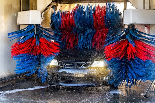 Car going through an automated car wash machine.