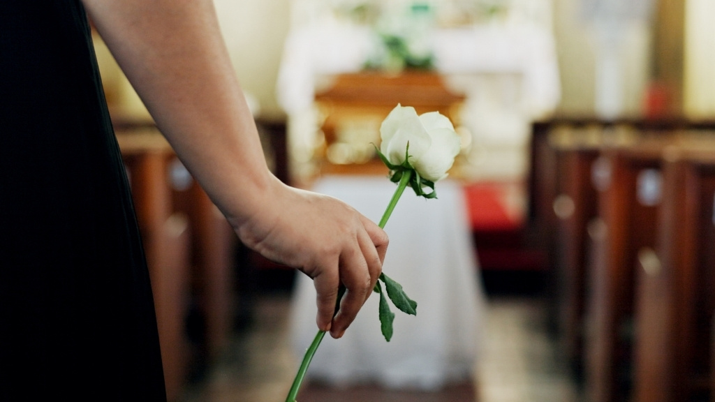 Hand Carrying Flower At Funeral