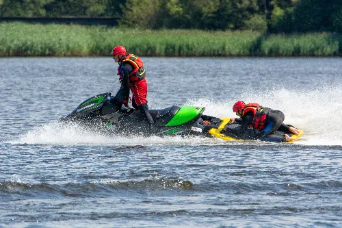 Jet ski lifeguard rescuing boater after jet ski accident in Myrtle Beach, South Carolina